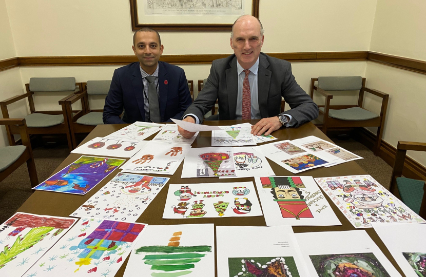 Leo Docherty MP and Hish Awad, Managing Director of Viasat UK, pick the winning entries of Leo's Xmas Card Competition in Parliament