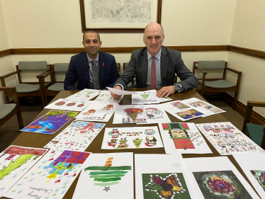 Leo Docherty MP and Hish Awad, Managing Director of Viasat UK, pick the winning entries of Leo's Xmas Card Competition in Parliament