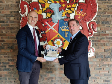 Leo with Rushmoor Borough Council Leader Cllr David Clifford, handing over the Leisure and Cultural Hub Survey
