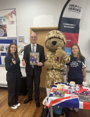 Leo Docherty MP with two Help for Heroes members and 'Hero Bear', the Help for Heroes mascot.